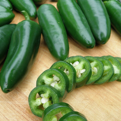 Fresh green jalapeno peppers, whole and sliced, ready for cooking and gardening. HarvestNest Seeds