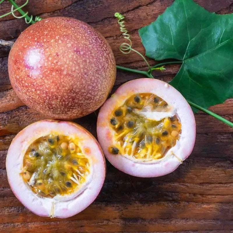 Fresh Purple Passion Fruit sliced open with juicy golden pulp, perfect for tropical gardens and exotic fruit lovers. HarvestNest Seeds